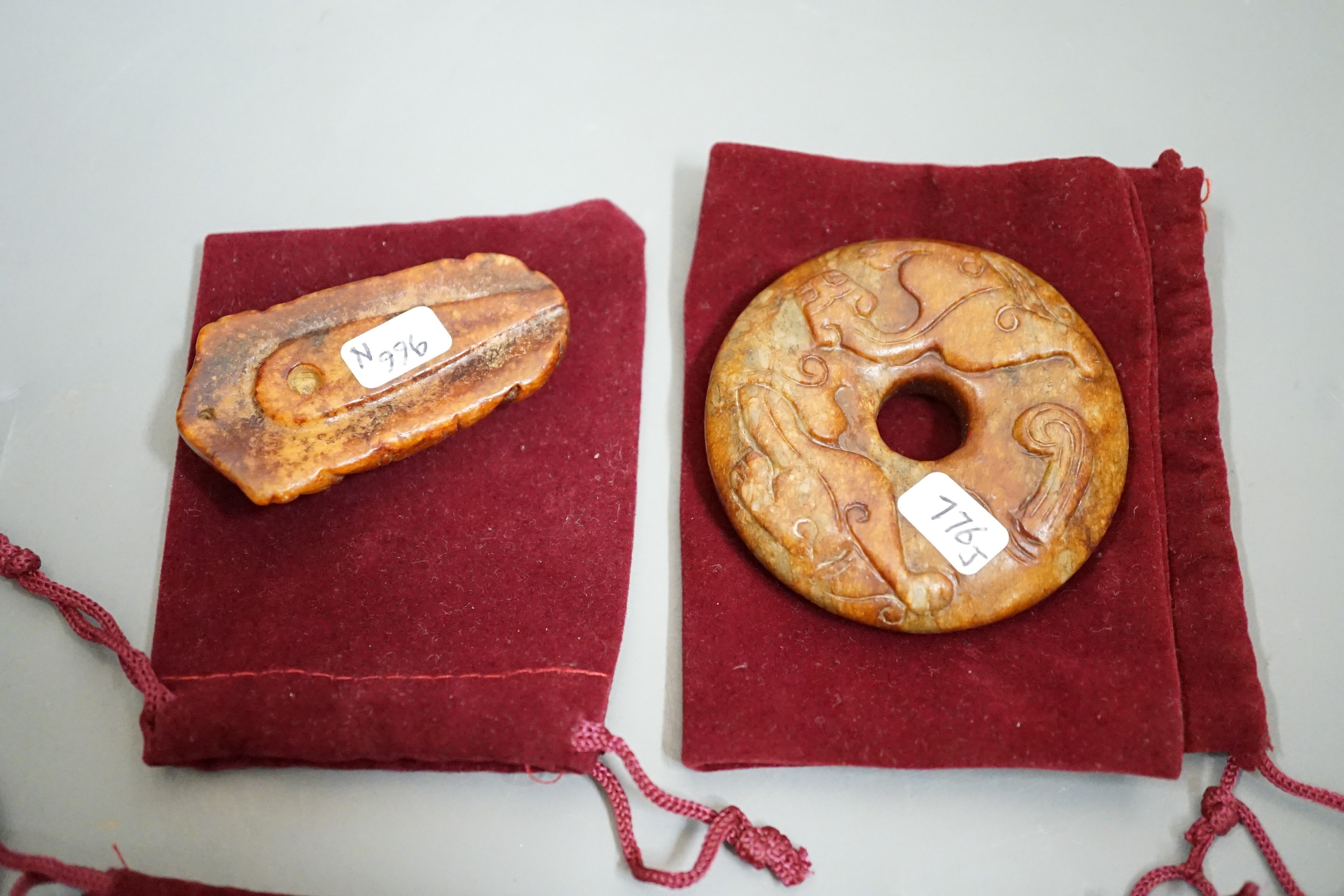 Four Chinese archaistic jade carvings - three bi discs and a cicada, largest 7cms